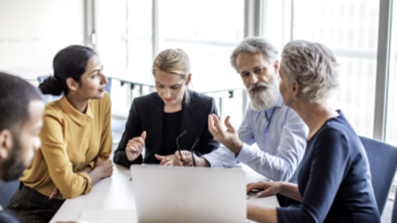Business team in discussion at table.